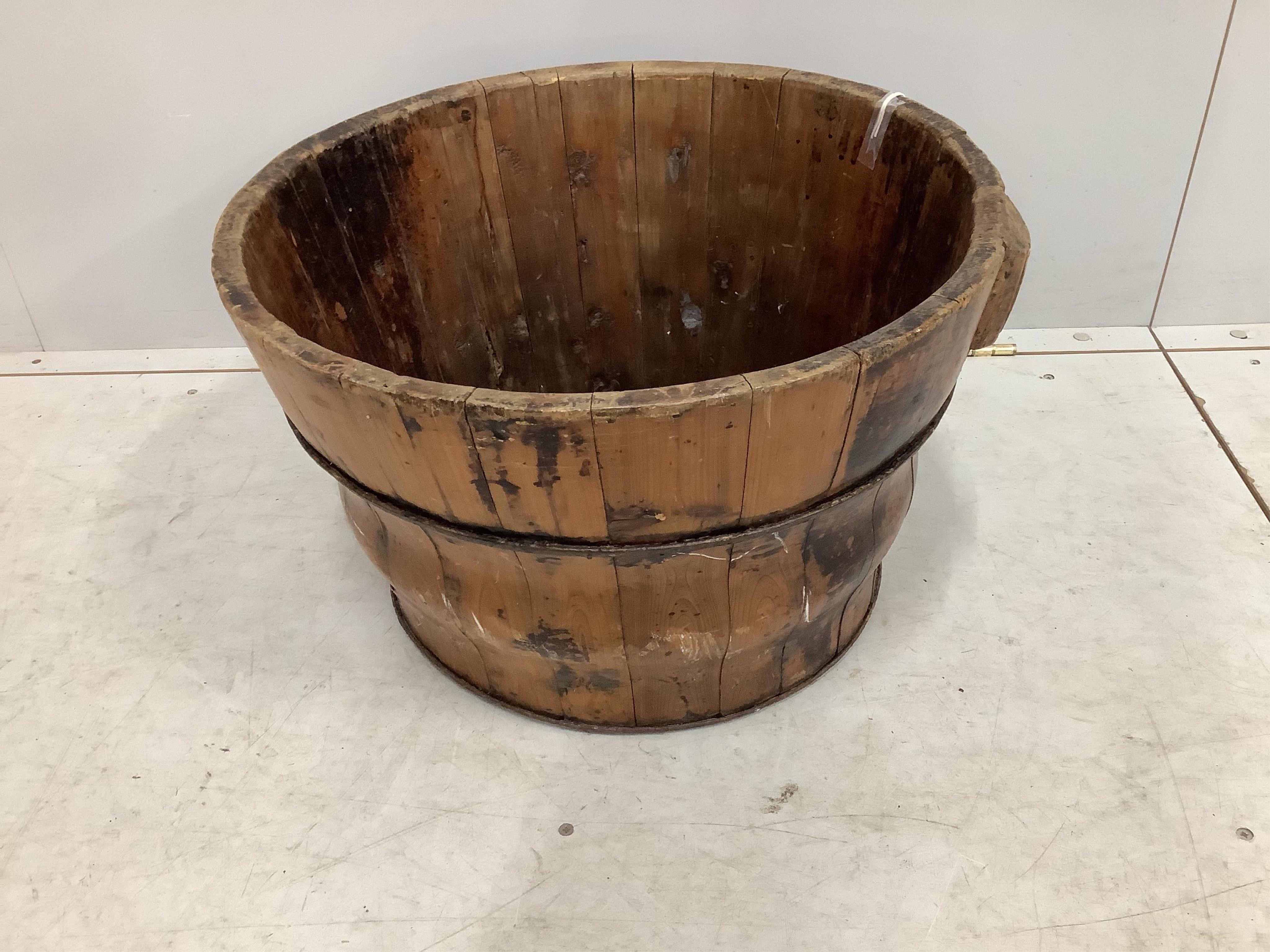 A circular Chinese staved pine pail, diameter 56cm, height 34cm. Condition - fair